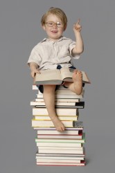 Boy sitting on books